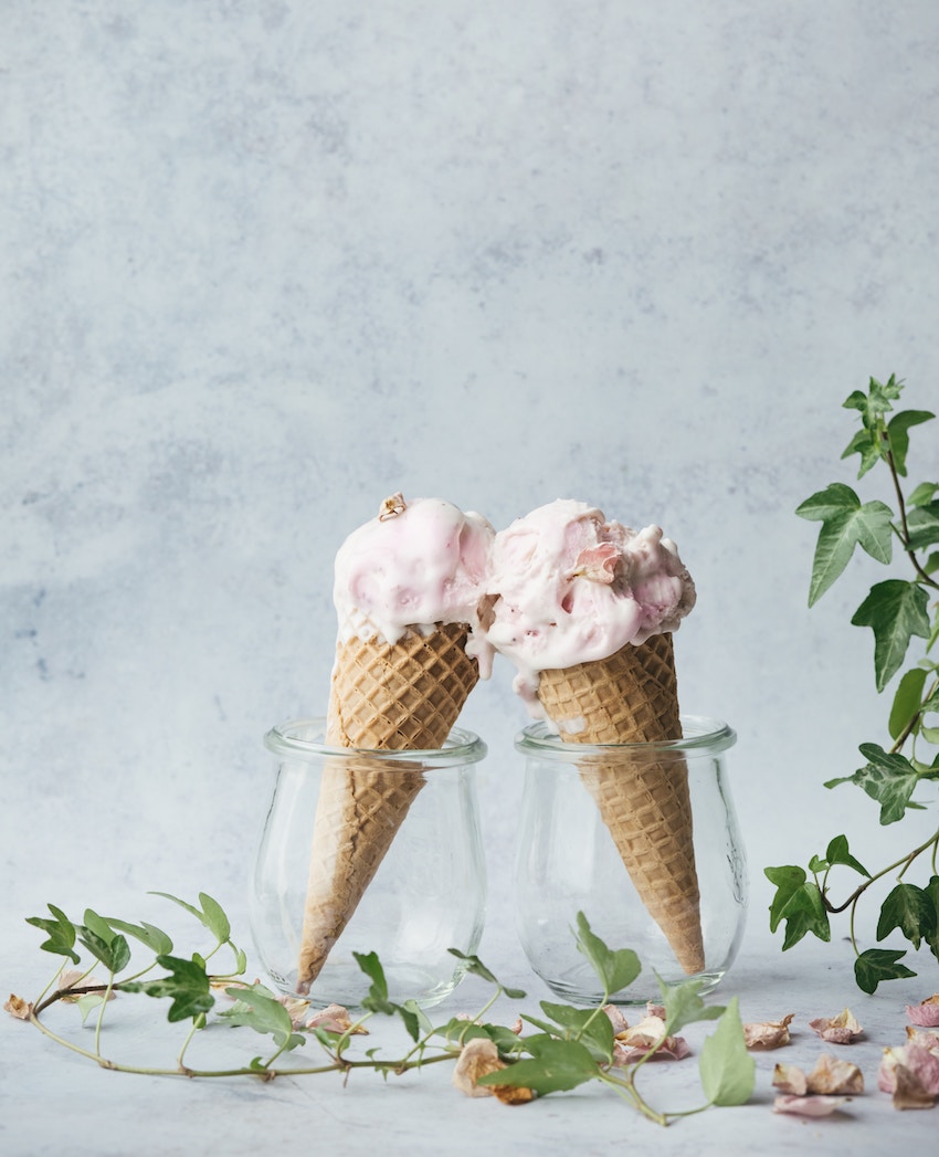 two pink ice creams in glass jars