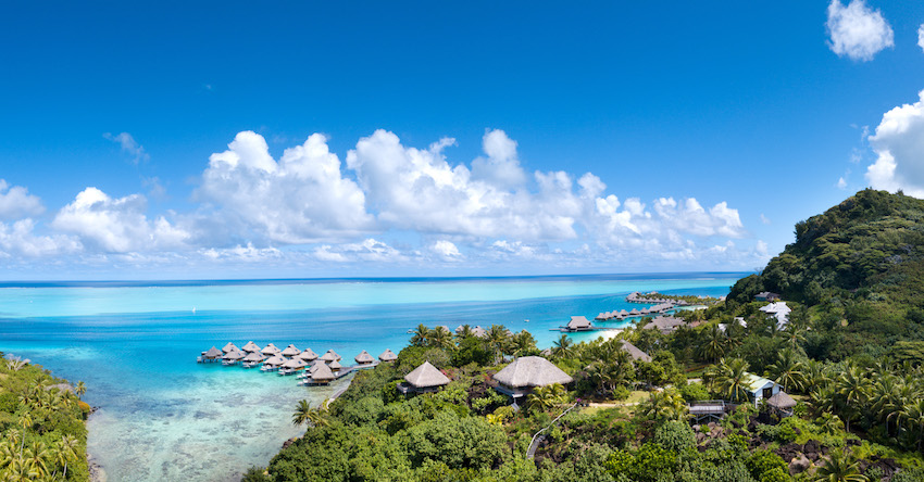 Looking out to turquoise sea over water villas - Bora Bora