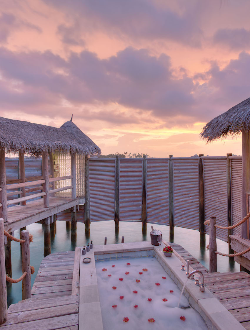 Romantic outdoor jacuzzi on deck of over water villa, the Maldives