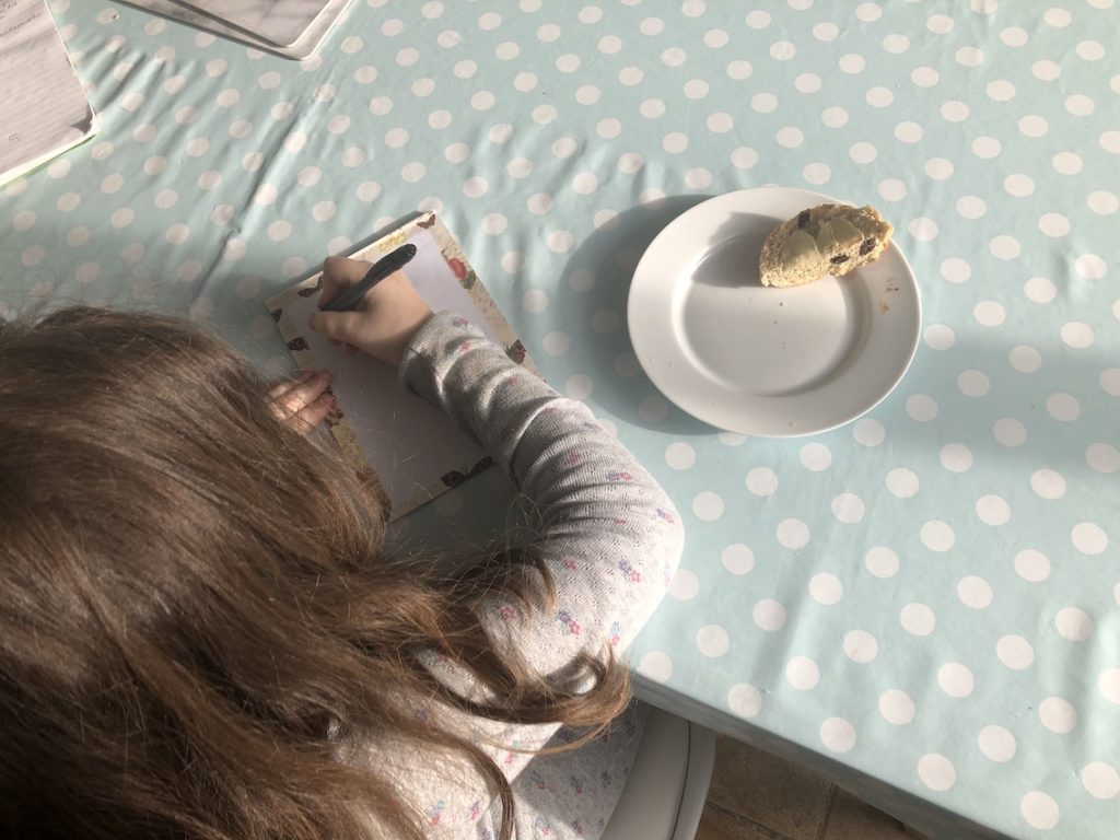Girl writing letter at table