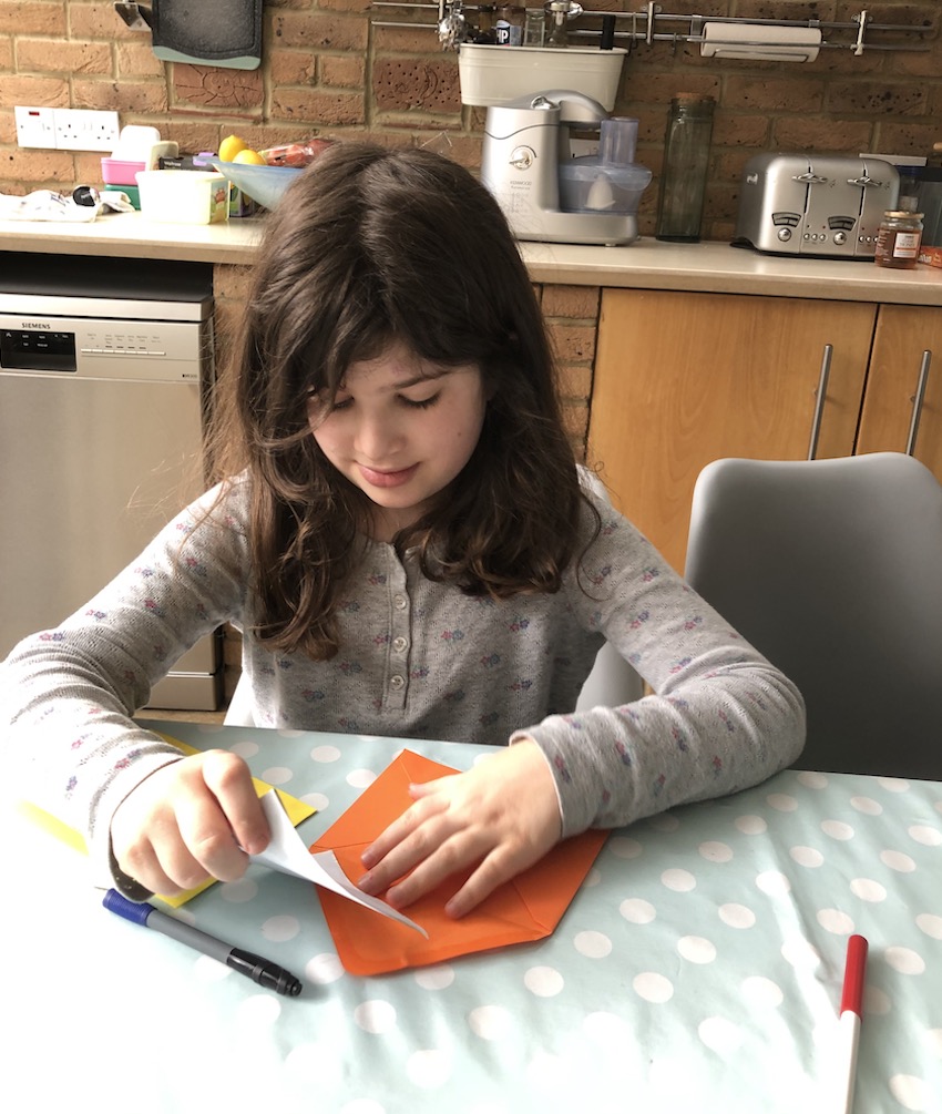 Girl putting letter in to envelope