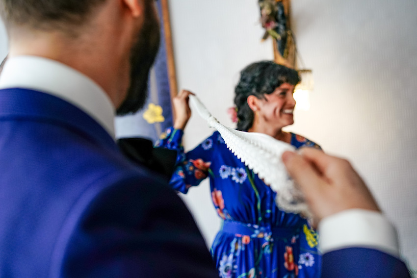 Couple on wedding day taking part in hand tying ceremony