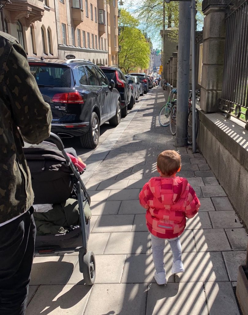 Patchwork Kids: Toddler walking on pavement next to pram