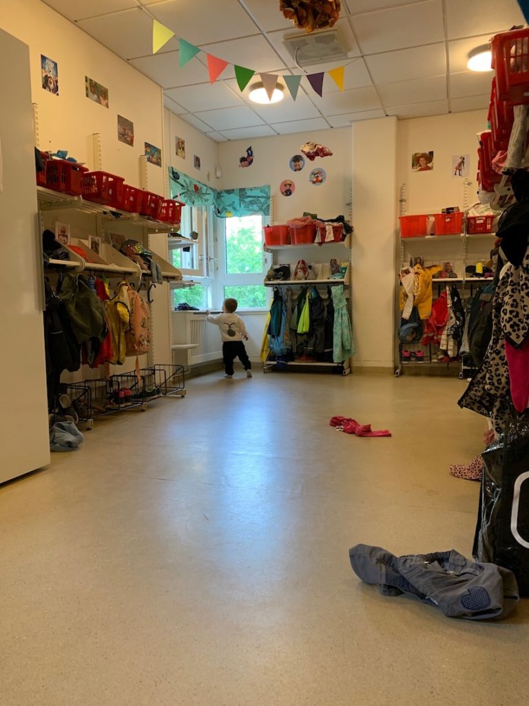 Toddler at nursery looking out of window