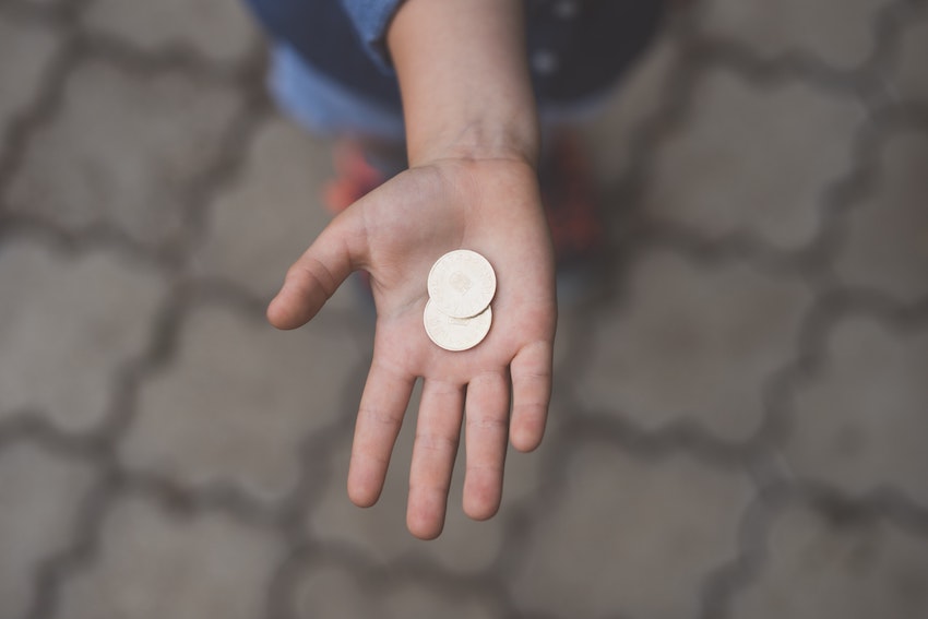 hand holding pocket money coins