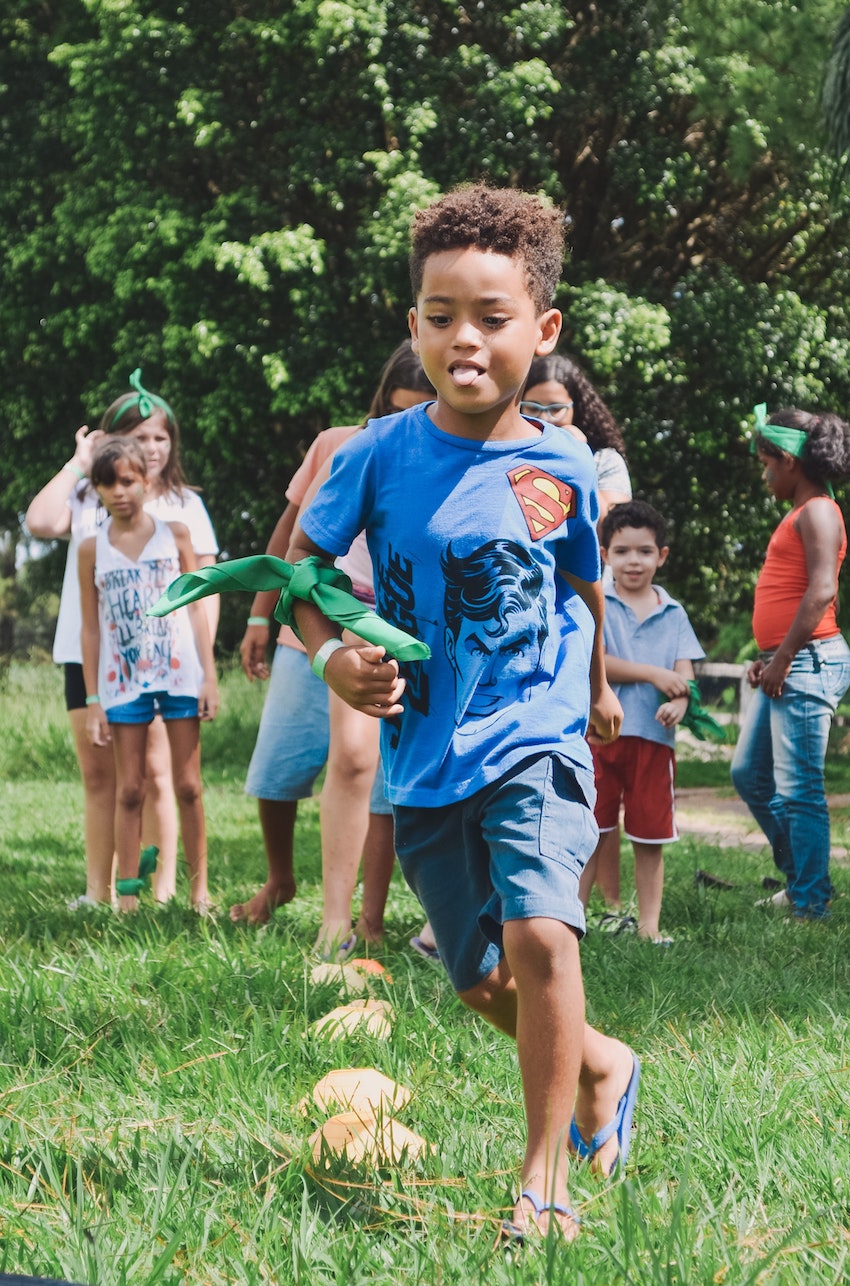 child playing summer fair games in garden