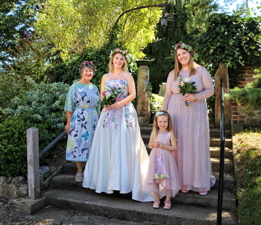 Bride, mother, bridesmaid and flower girl at their small wedding ceremony during Covid-19 pandemic