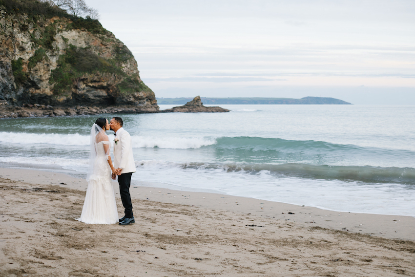 Bride and Groom kissing on Porthpean beach, Cornwall